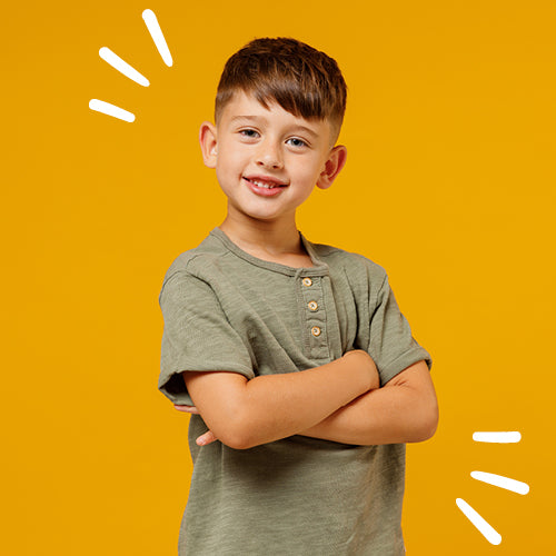 Child wearing a green shirt on a yellow background